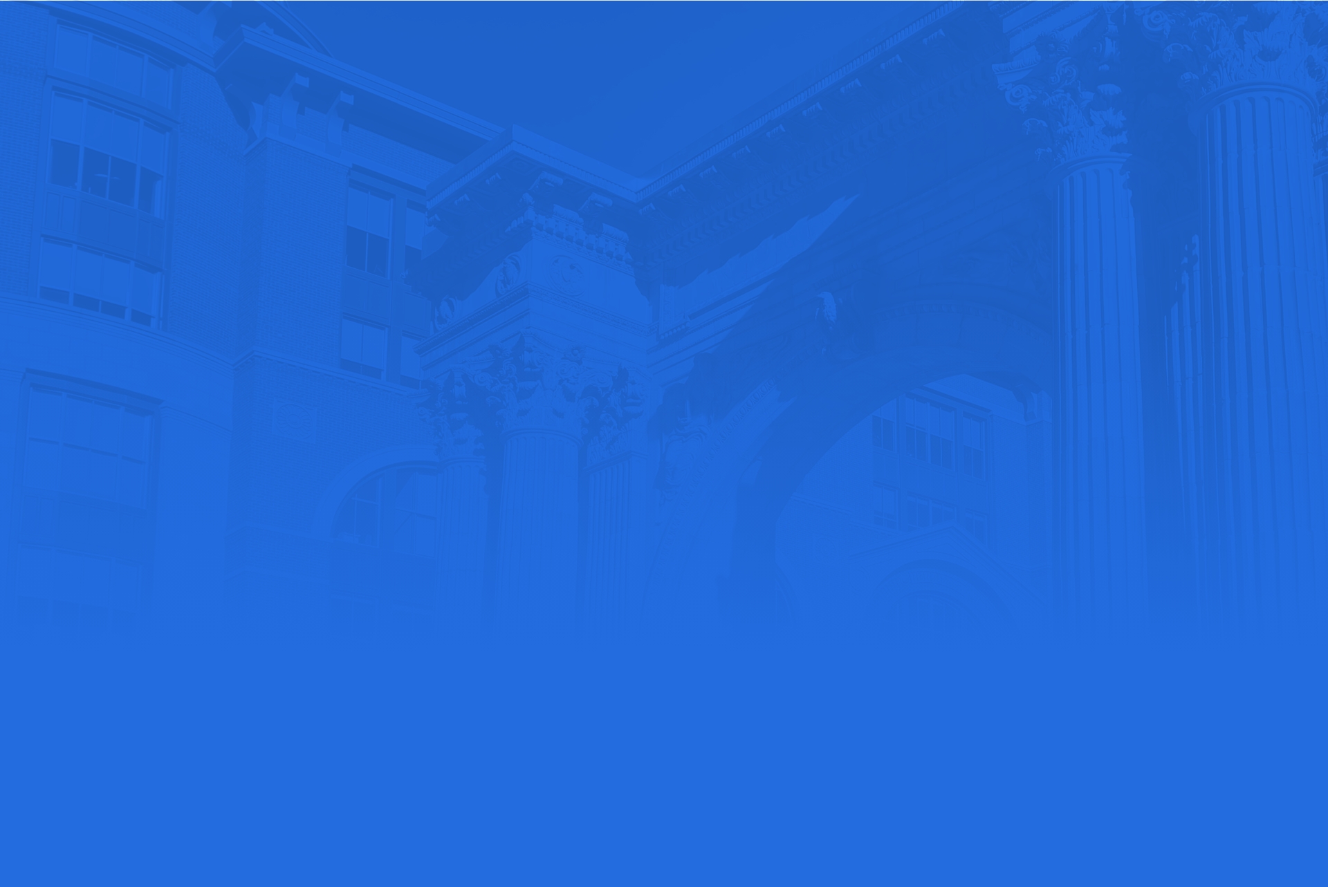 A blue-toned image displaying classical architectural elements, including ornate columns and intricate detailing. The foreground fades into a solid blue color, obscuring the lower part of the structure.
