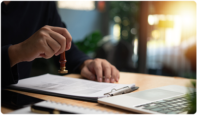Person using notary stamp on documents