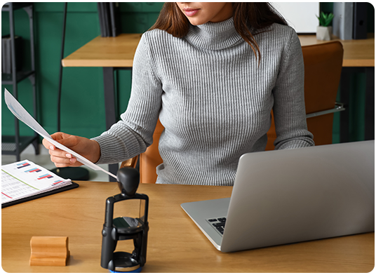 Woman on computer ordering notary public stamps and supplies